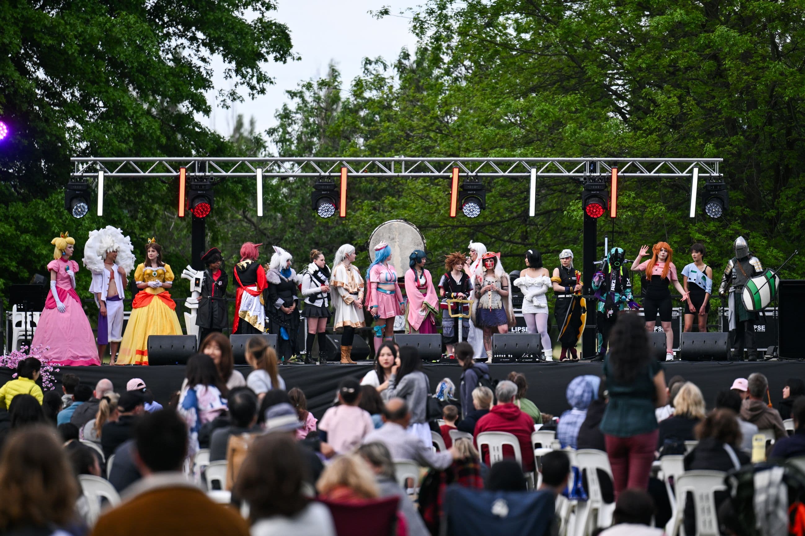 Participants showcase costumes on stage during the Canberra Nara Candle Festival cosplay competition.