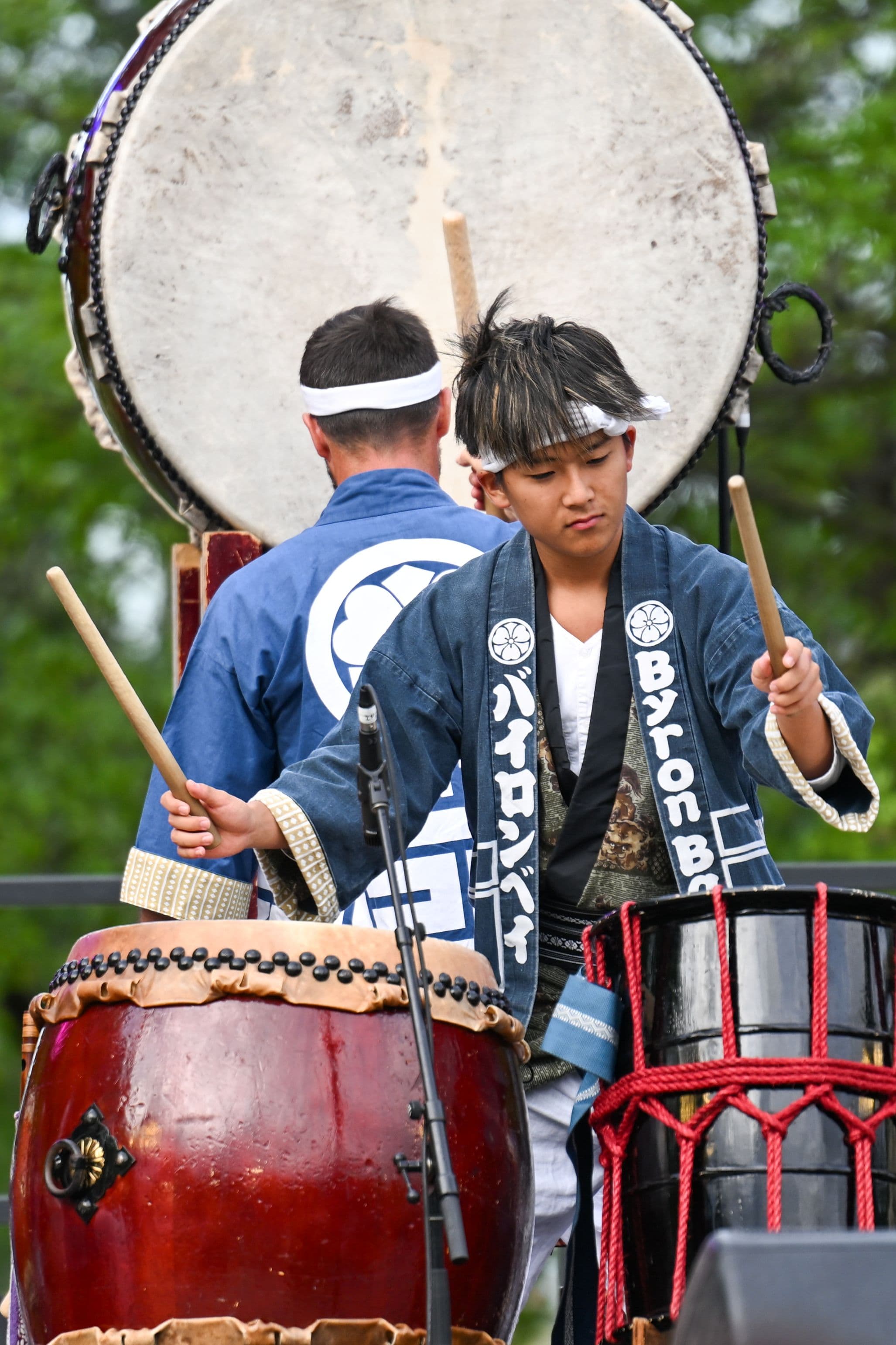 Taiko drummers perform on stage at the Canberra Nara Candle Festival, showcasing traditional Japanese percussion.
